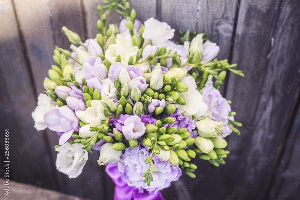 Bridal bouquet with lilac ribbon close up