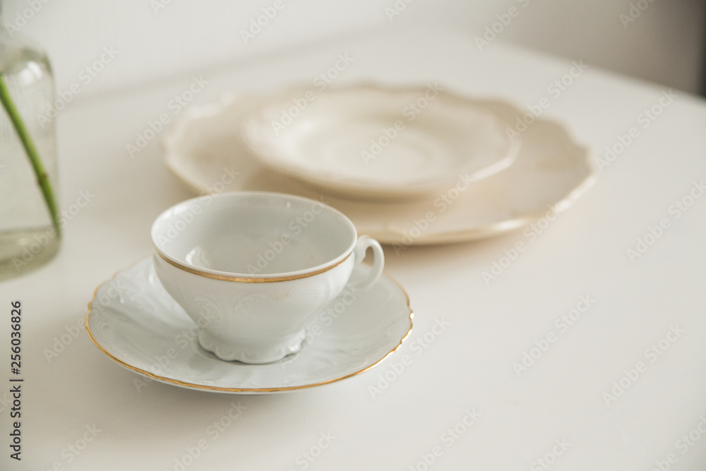 white cup and saucer on white table white cup and saucer on white table