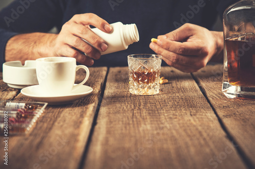 man hand  whiskey with drug