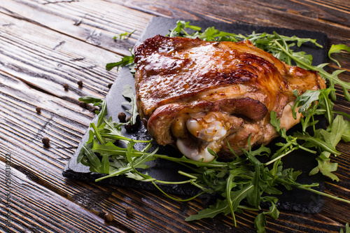 Thigh turkey baked in the oven with spices on black stone board. Healthy food. Thanksgiving dinner. photo