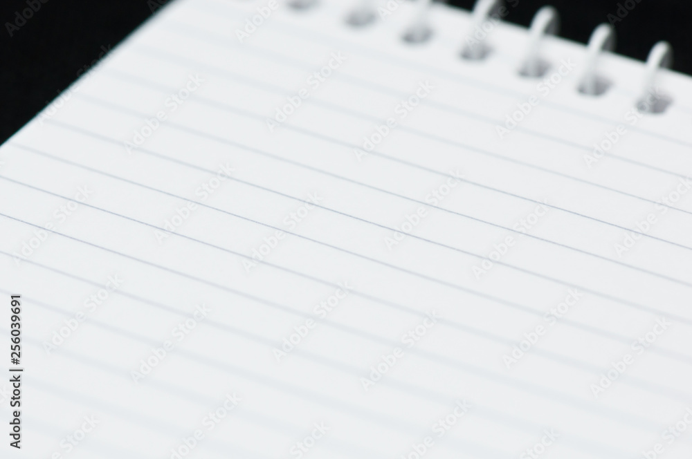 Blank sheet of a notebook on black background Blank sheet of a notebook on black background