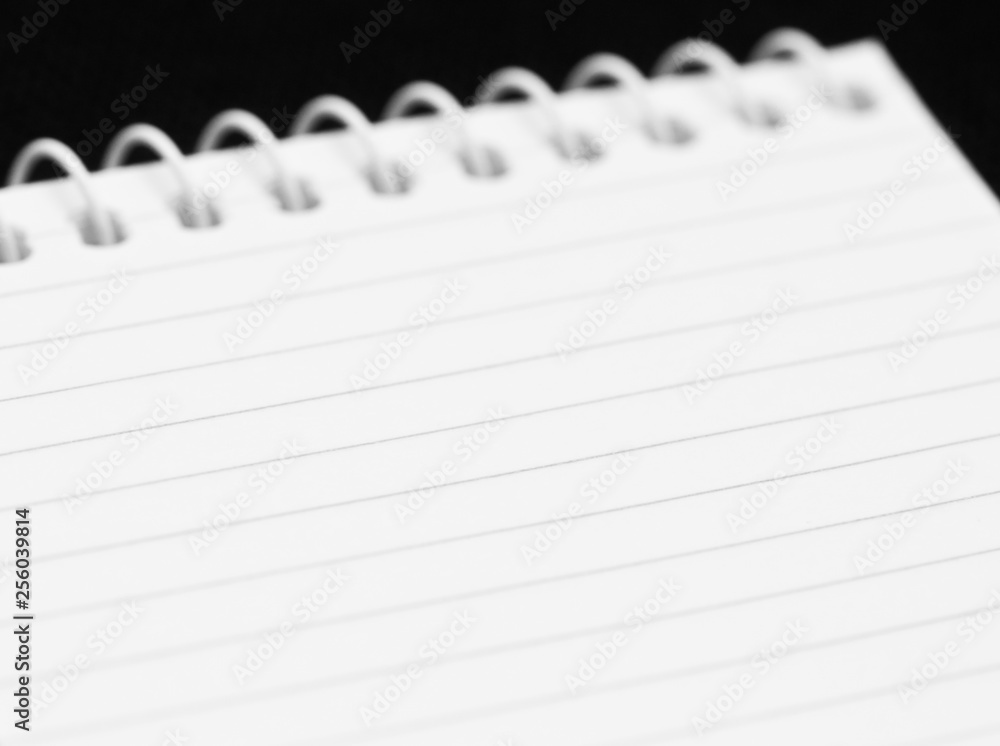 Blank sheet of a notebook on black background Blank sheet of a notebook on black background