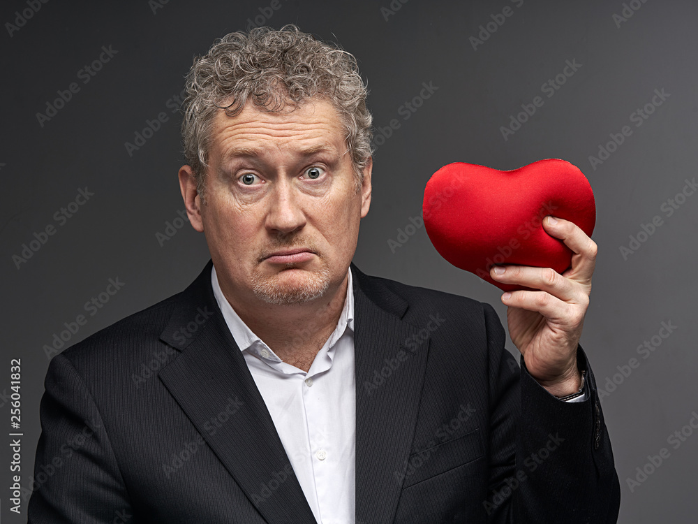business man with heart puzzled, perplexed, confused, baffled, bewildered, taken aback business man with heart puzzled, perplexed, confused, baffled, bewildered, taken aback