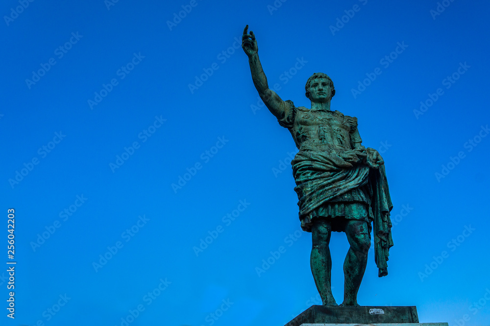 Fototapeta premium Roman emperor bronze statue on blue sky background