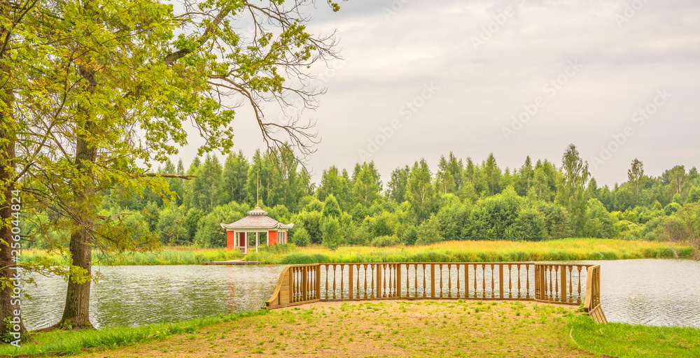 Summer landscape with gazebo on river bank in park Summer landscape with gazebo on river bank in park