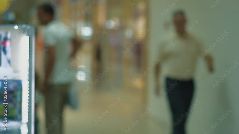 People walk around the shopping center. Slow motion. People walk around the shopping center. Slow motion.