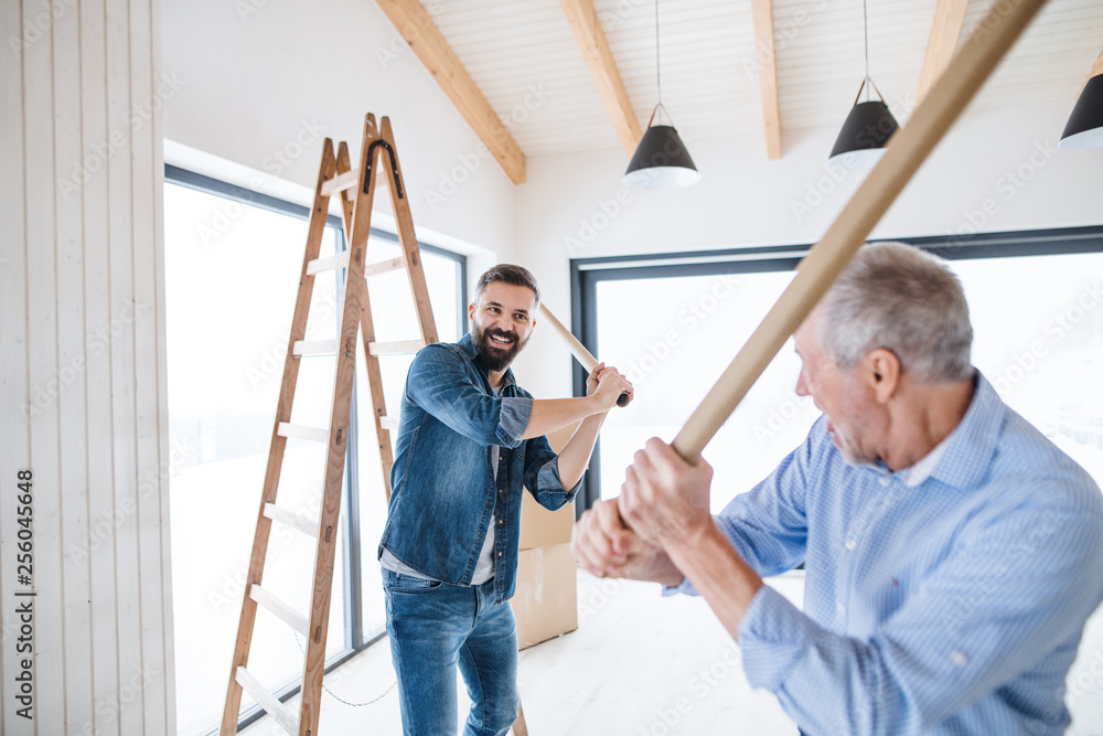 Two men having fun when furnishing new house, a new home concept.