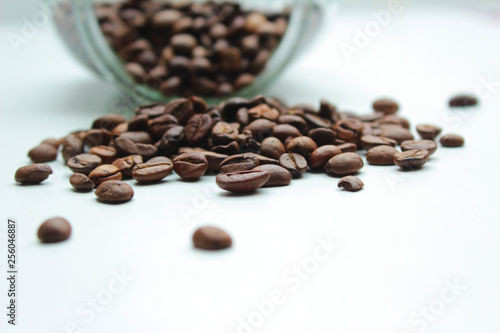 Heap of coffee beans from jar.