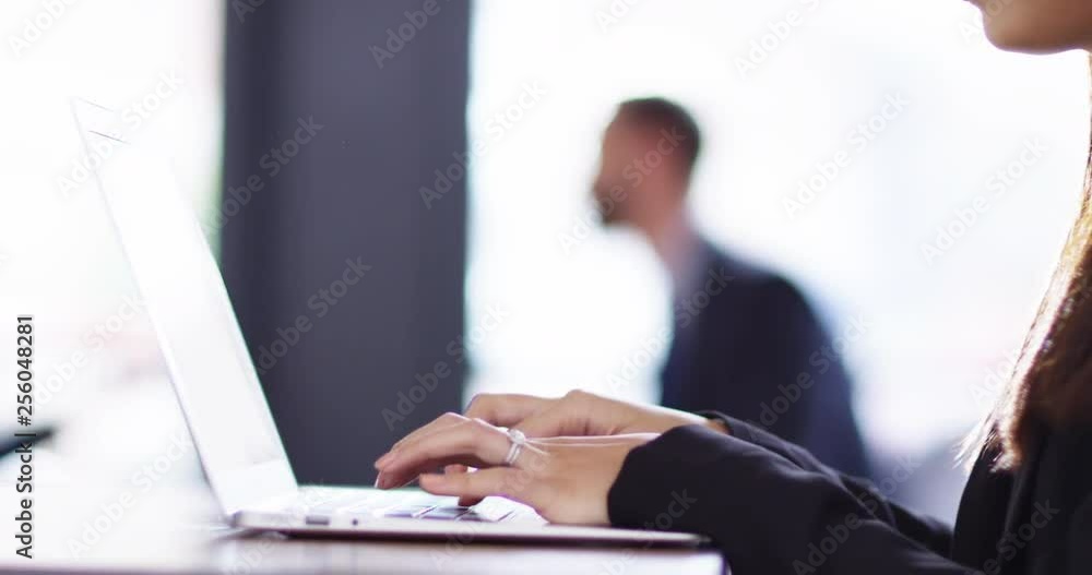 4K Close up of beautiful Asian businesswoman typing on laptop & smiling 4K Close up of beautiful Asian businesswoman typing on laptop & smiling