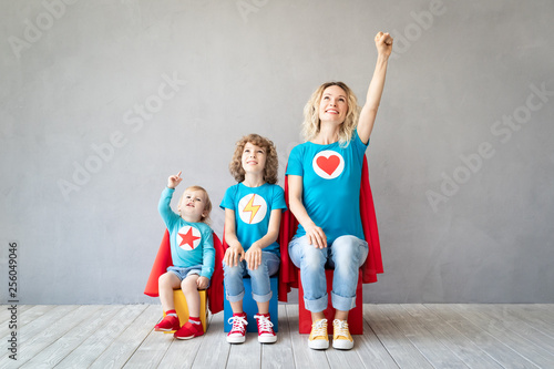 Bild auf Leinwand Family of superheroes playing at home