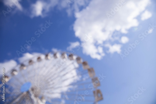 Blured ferris wheel against the sky