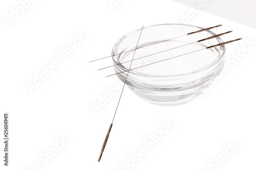 Silver needles for traditional Chinese acupuncture medicine. Isolated white background.