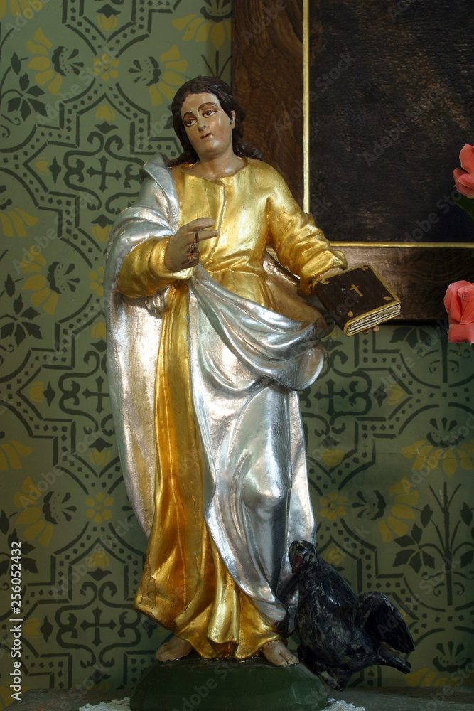 Obraz premium Saint John the Evangelist, statue on the Sacred Heart of Jesus altar in the Parish Church of the Holy Cross in Zacretje, Croatia