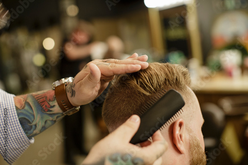 Close up of barber styling man's hair photo