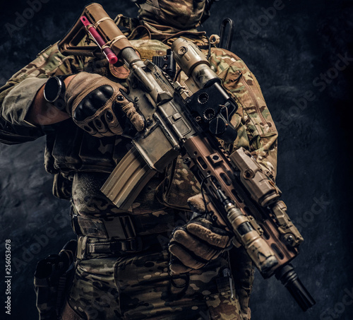 Принти на полотні Special forces soldier in camouflage uniform holding HK 416 rifle