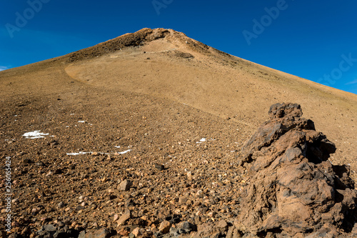 Majestic volcanic cone rising above spectacular lava shaped landscape.