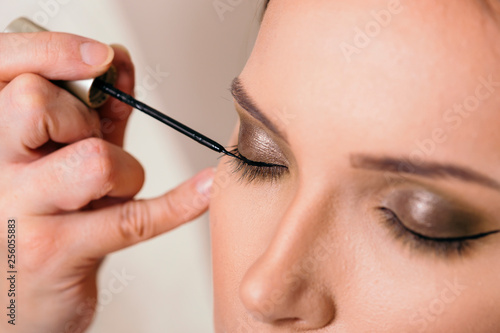 Applying eyeliner on eyelids