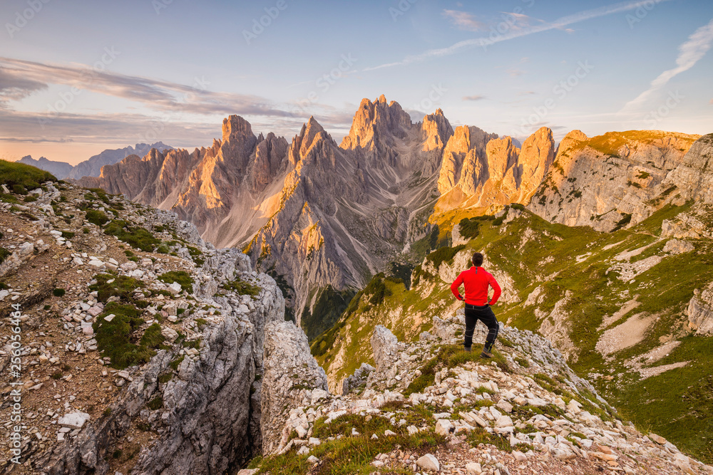 mountaineer in front of the tops Cadini di Misurina range in National Park Tre Cime di Lavaredo