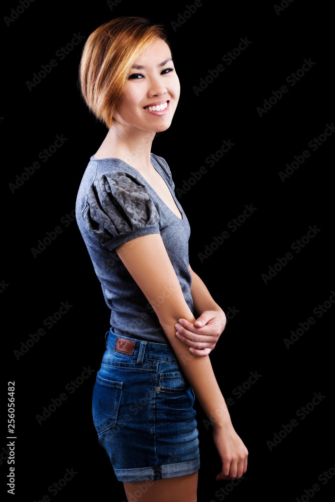 Smiling Slim Asian American Woman In Jean Shorts And Sweater Smiling Slim Asian American Woman In Jean Shorts And Sweater