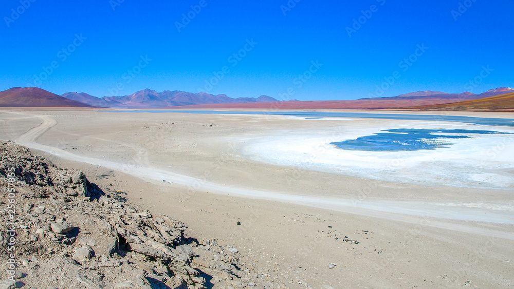 Barren landscape of altiplano with lagoon in Cordillera de Lipez, Bolivia, South America Barren landscape of altiplano with lagoon in Cordillera de Lipez, Bolivia, South America