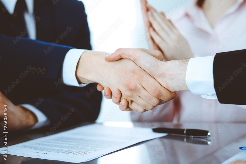 Business people shaking hands finishing up a meeting. Handshake at successful negotiation Business people shaking hands finishing up a meeting. Handshake at successful negotiation