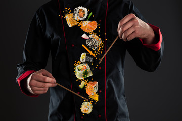 Gordijnen Sushi bar Chef-kok met vliegende sushi  © Jag_cz
