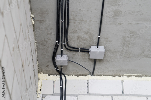 Manufacture of electrical wiring in a brick house.