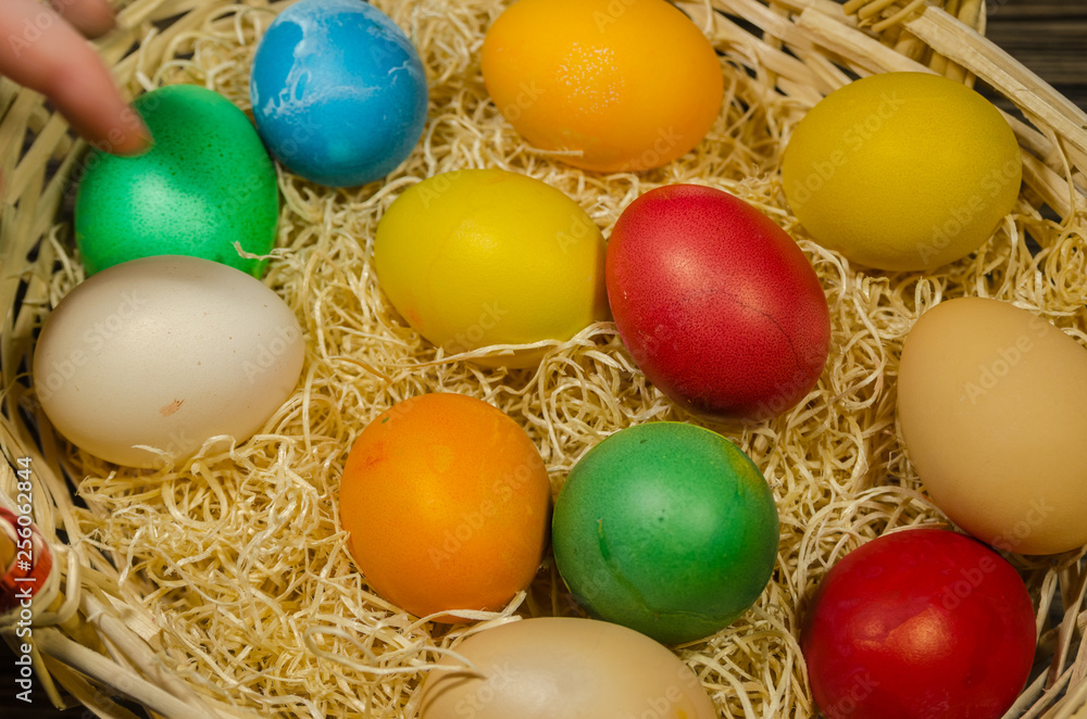 colored eggs in wicker basket colored eggs in wicker basket