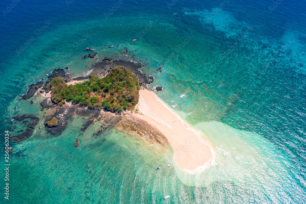 aerial vertical view of a beautiful tropical desert island with turquoise water and yellow sand in the indian ocean