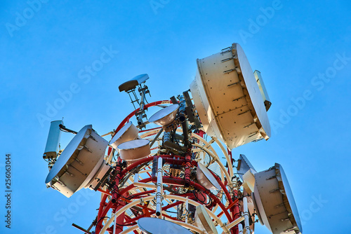 Upward view of Communication Radio antenna Tower , microwave antenna tower on blue sky background 