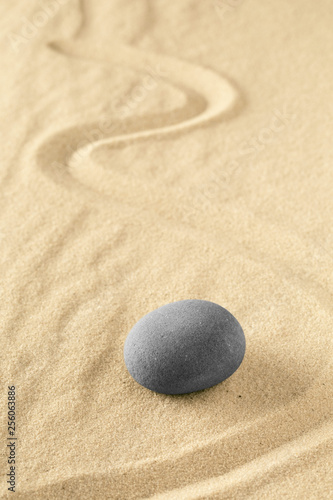 Healing treatment or spiritual therapy trough relaxation and meditation concentrating on a zen stone garden. Spa wellness background with sand texture.