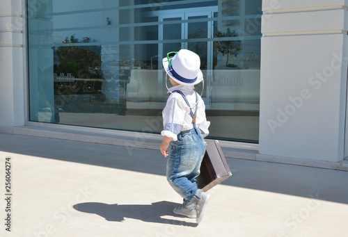 Baby traveler with a suitcase