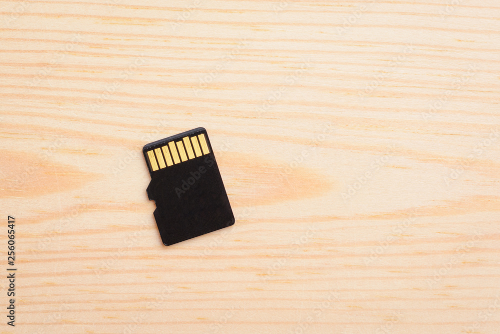 Micro sd memory card on light wooden background Micro sd memory card on light wooden background