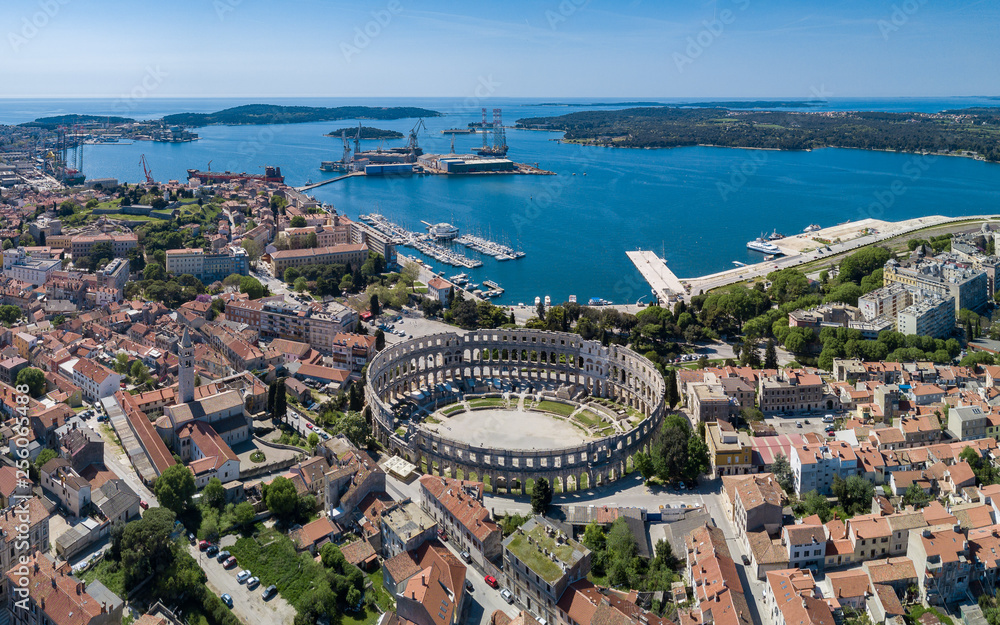 Pula aerial drone shot. The Arena is the only remaining Roman amphitheatre to have four side towers and with all three Roman architectural orders entirely preserved. It was constructed in 27 BC–68 AD