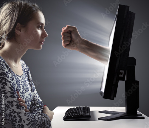 Pretty lady looking at the monitor - Internet violence symbol