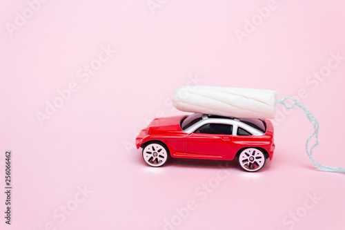 Joy car, Days of menstruation, hygienic tampon for menstruation. The concept of delivery of tampons. It's red