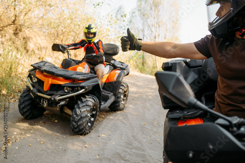 ATV rider showing thumbs up to his partner 