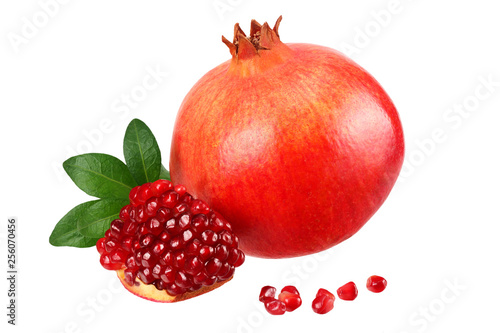 pomegranate fruit with seeds and green leaves isolated on white background