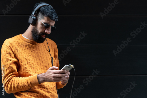 Hipster Man Listening Music on Headphones.