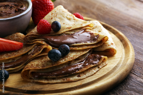 Tableau sur toile Delicious Tasty Homemade crepes with chocolate or pancakes with raspberries and