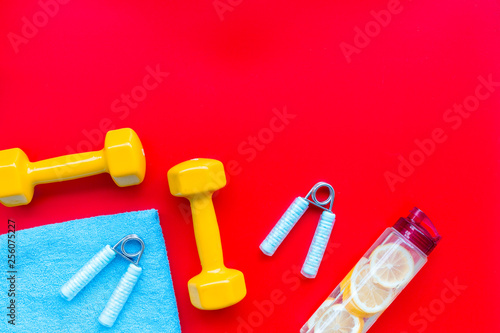 Sport with bars, towel, water and wrist builder red background top view space for text © 9dreamstudio
