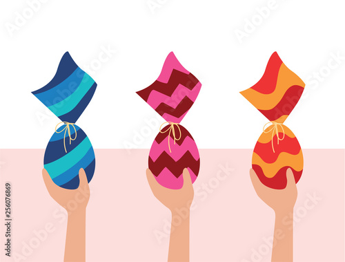 Colorful Easter Eggs. Kids egg hunt. Hands holding three chocolate Eggs wrapped in colorful package. Brazilian Easter egg.