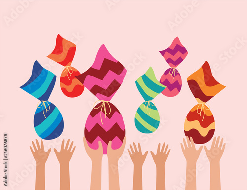 Happy Easter holiday. kids hands catching Easter eggs in air. Chocolate wrapped in colorful pattern.