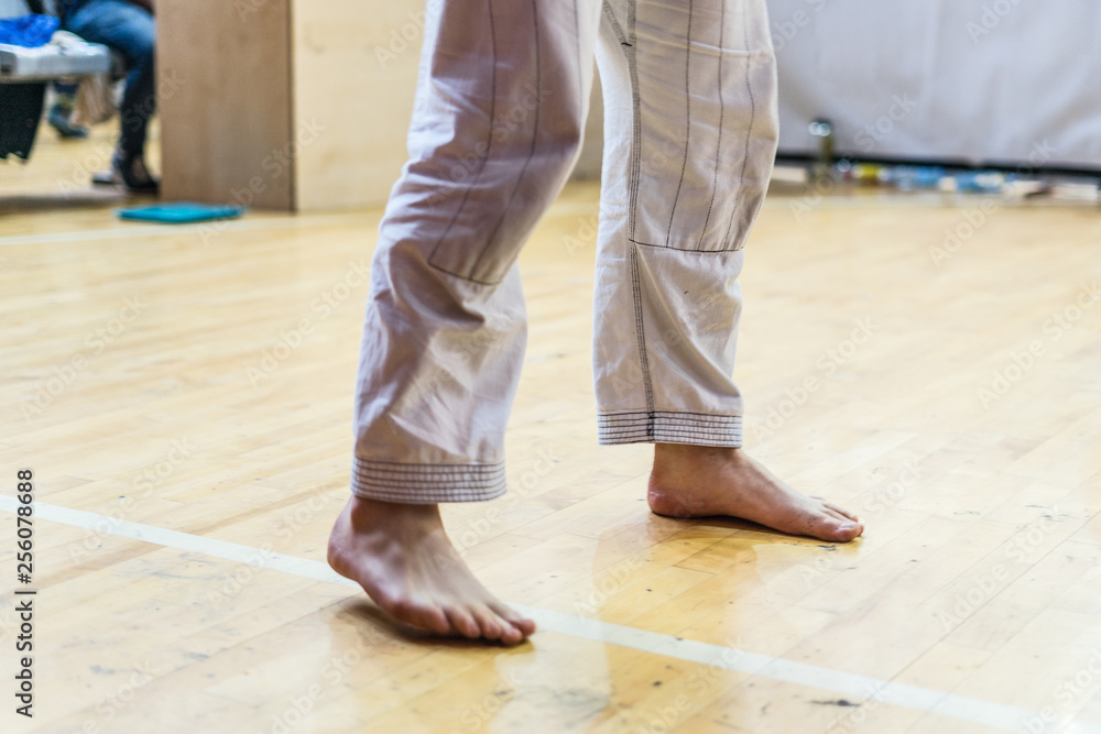 Close up on Brazilian Jiu Jitsu BJJ Judo fighter feet at the tournament waiting for the fight Close up on Brazilian Jiu Jitsu BJJ Judo fighter feet at the tournament waiting for the fight