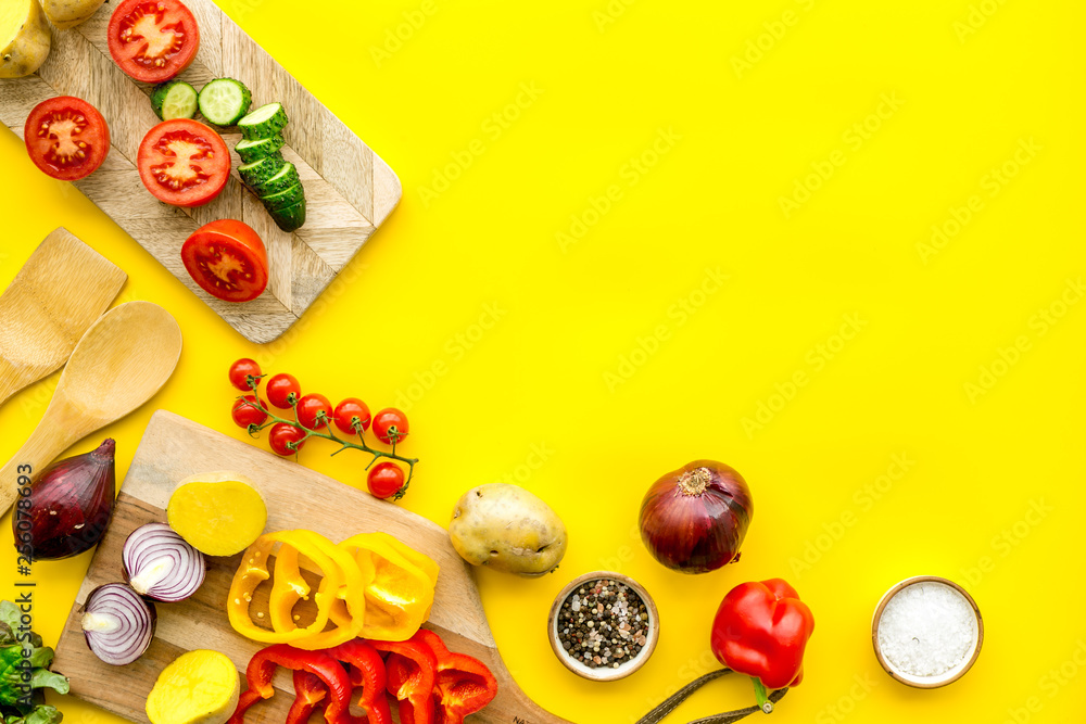 Fresh food ingredients for vegetarian kitchen on yellow background top view mock-up