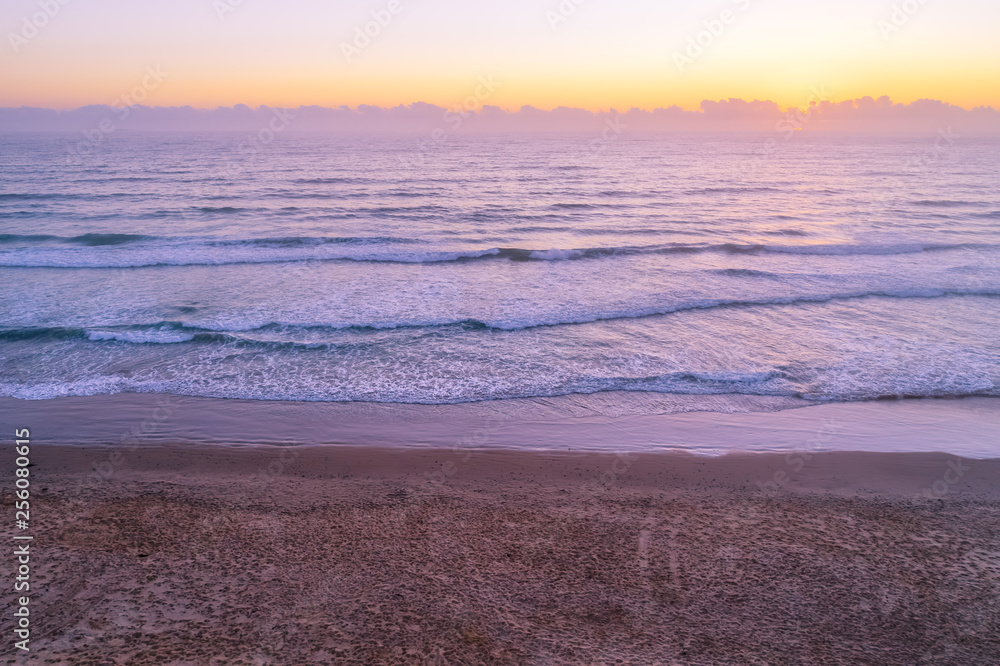 Sunrise over empty ocean beach with copy space