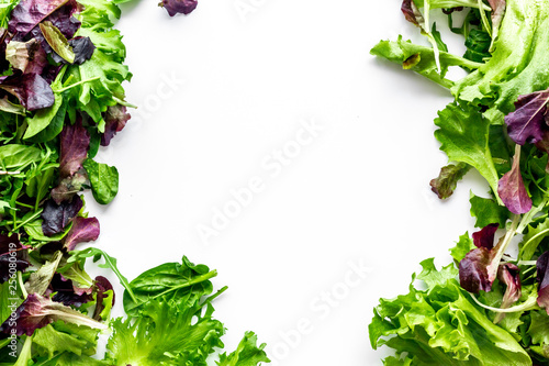 fitness food cooking with green and red salad mix on white background top view copyspace
