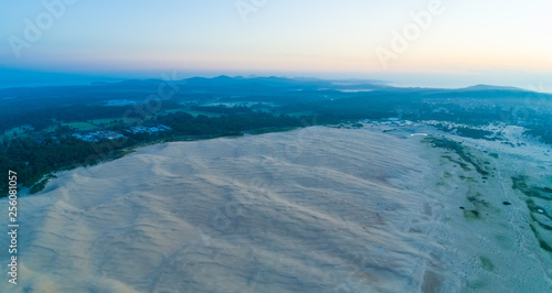 Aerial panorama of ocean coastline and famous landmark sand dunes. Anna Bay, New South Wales, Australia