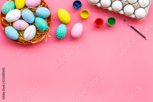 paint eggs for Easter celebration on pink background top view mock up
