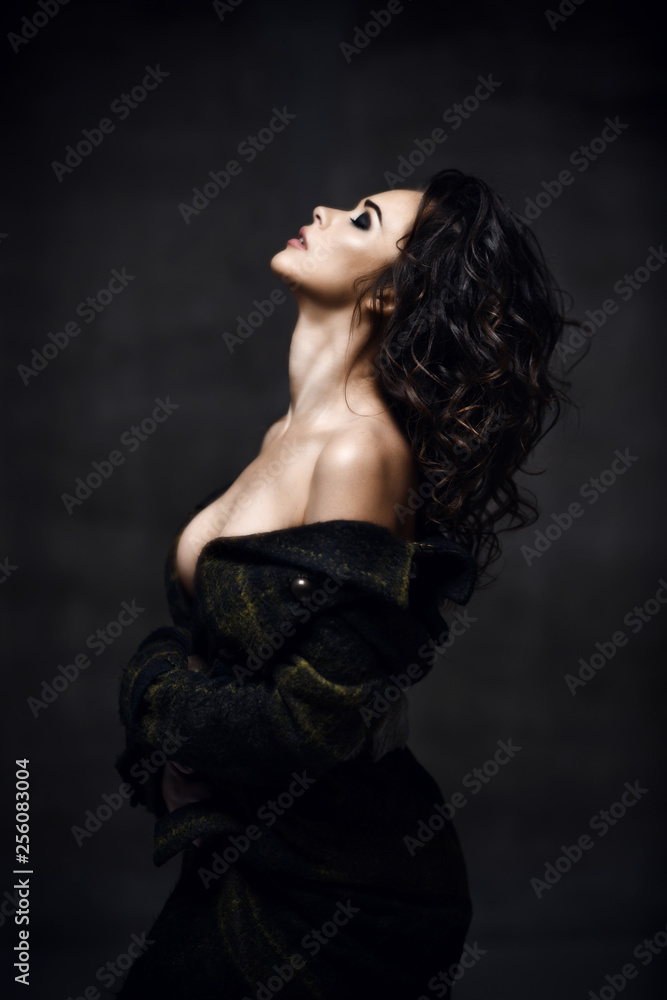 Young sensual beautiful sexy woman posing in summer fashion body jacket naked on dark 